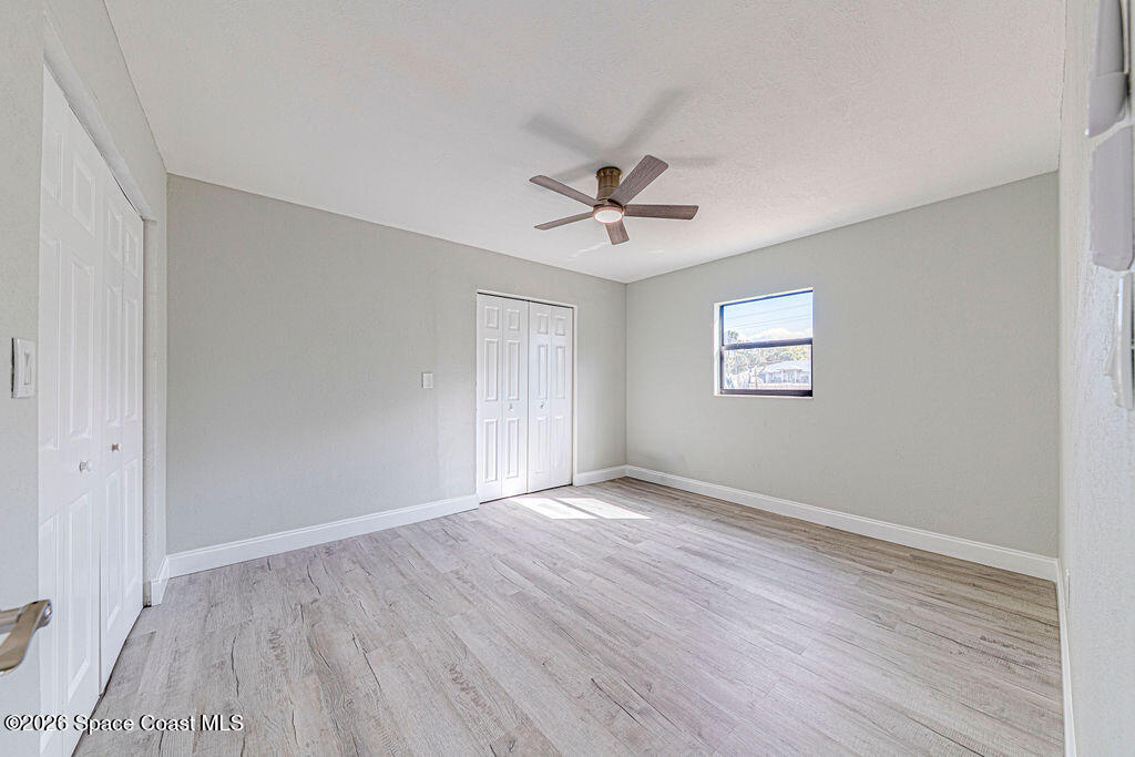 2773 Hickory Circle Mims, FL 32754 - Photo 21 of 45 a view of an empty room with wooden floor and a window