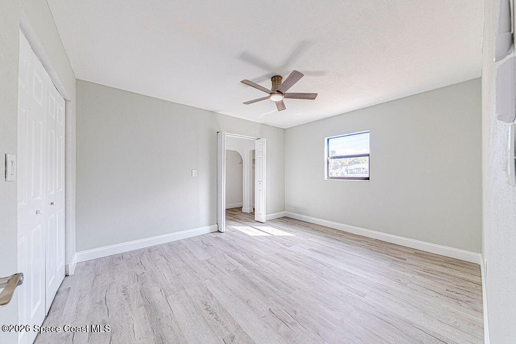 2773 Hickory Circle Mims, FL 32754 - Photo 22 of 45 a view of an empty room with a window and wooden floor