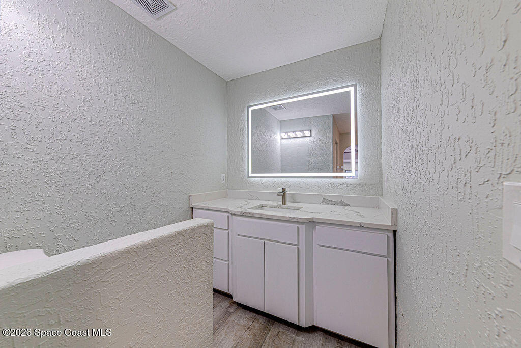 2773 Hickory Circle Mims, FL 32754 - Photo 32 of 45 a bathroom with a toilet sink and mirror