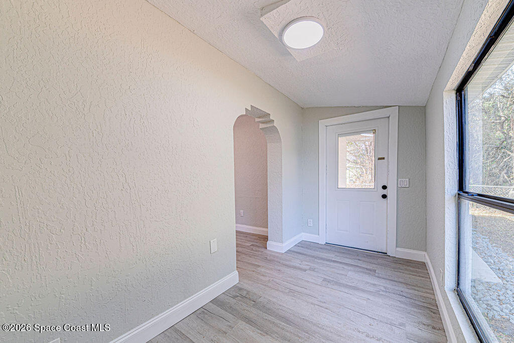 2773 Hickory Circle Mims, FL 32754 - Photo 36 of 45 an empty room with wooden floor and windows
