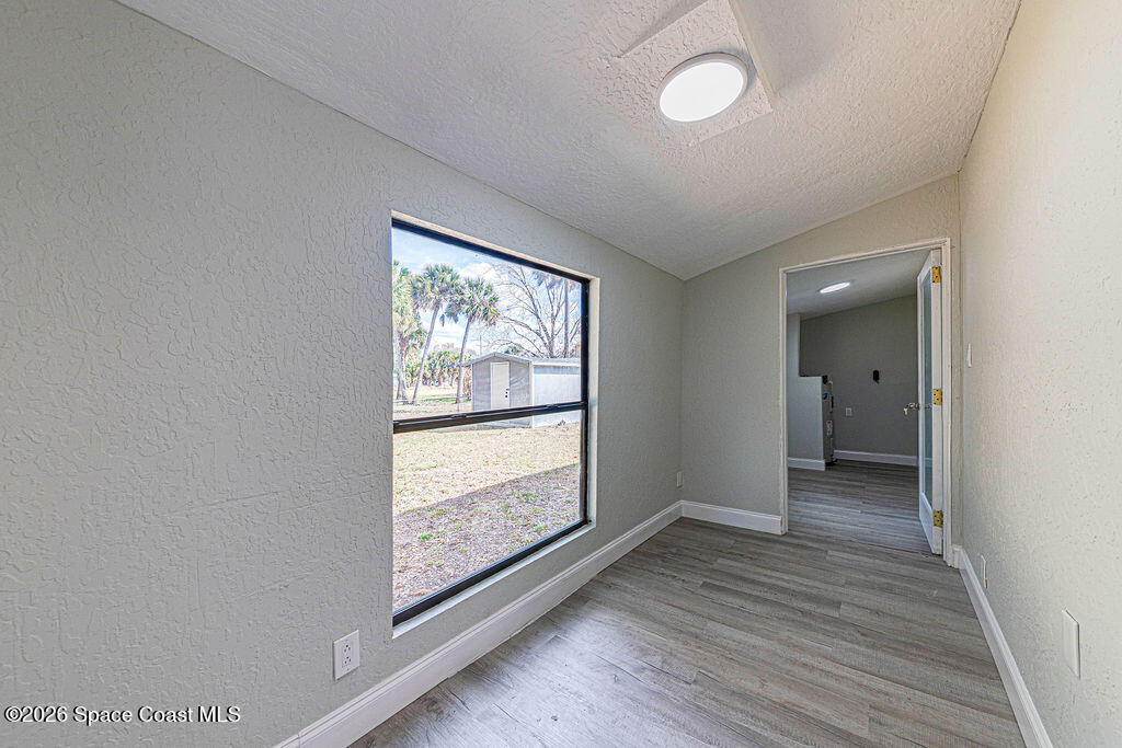 2773 Hickory Circle Mims, FL 32754 - Photo 37 of 45 a view of hallway with a large window and wooden floor