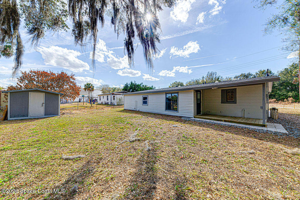2773 Hickory Circle Mims, FL 32754 - Photo 6 of 45 a view of an house with backyard space and a tree