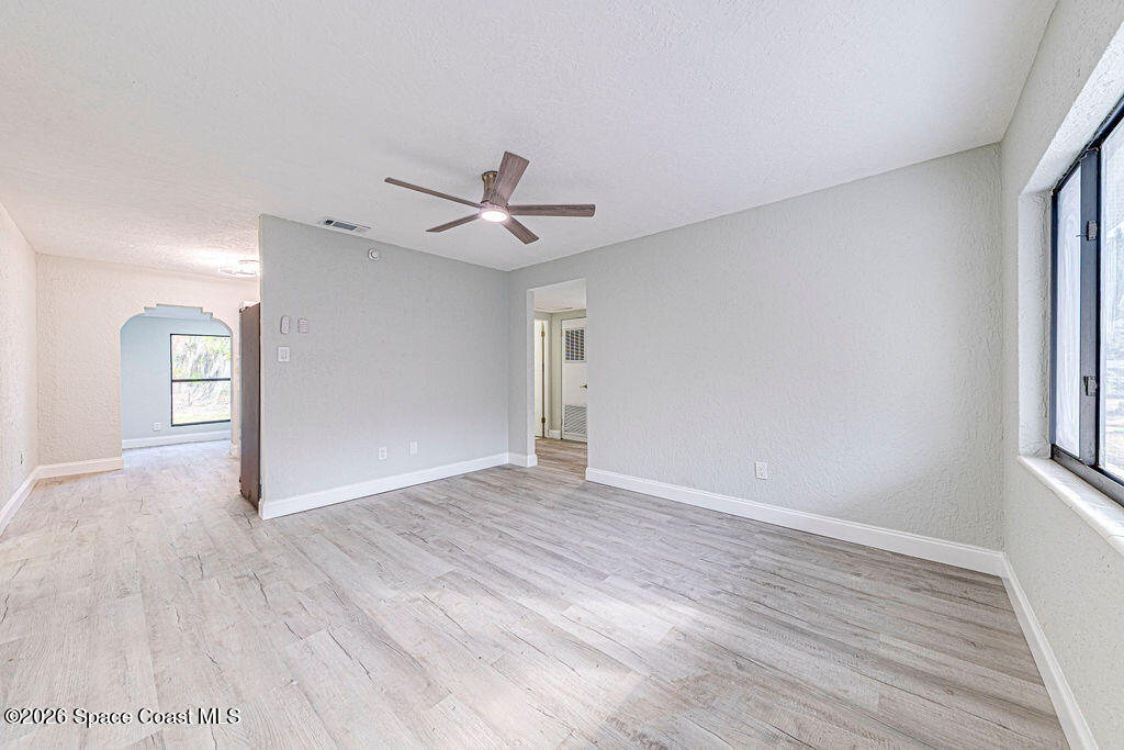 2773 Hickory Circle Mims, FL 32754 - Photo 10 of 45 an empty room with wooden floor and windows