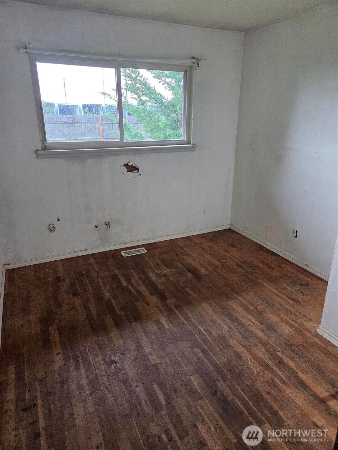 12001 Spanaway Loop Road South Tacoma, WA 98444 - Photo 11 of 20 a view of empty room with wooden floor and fan