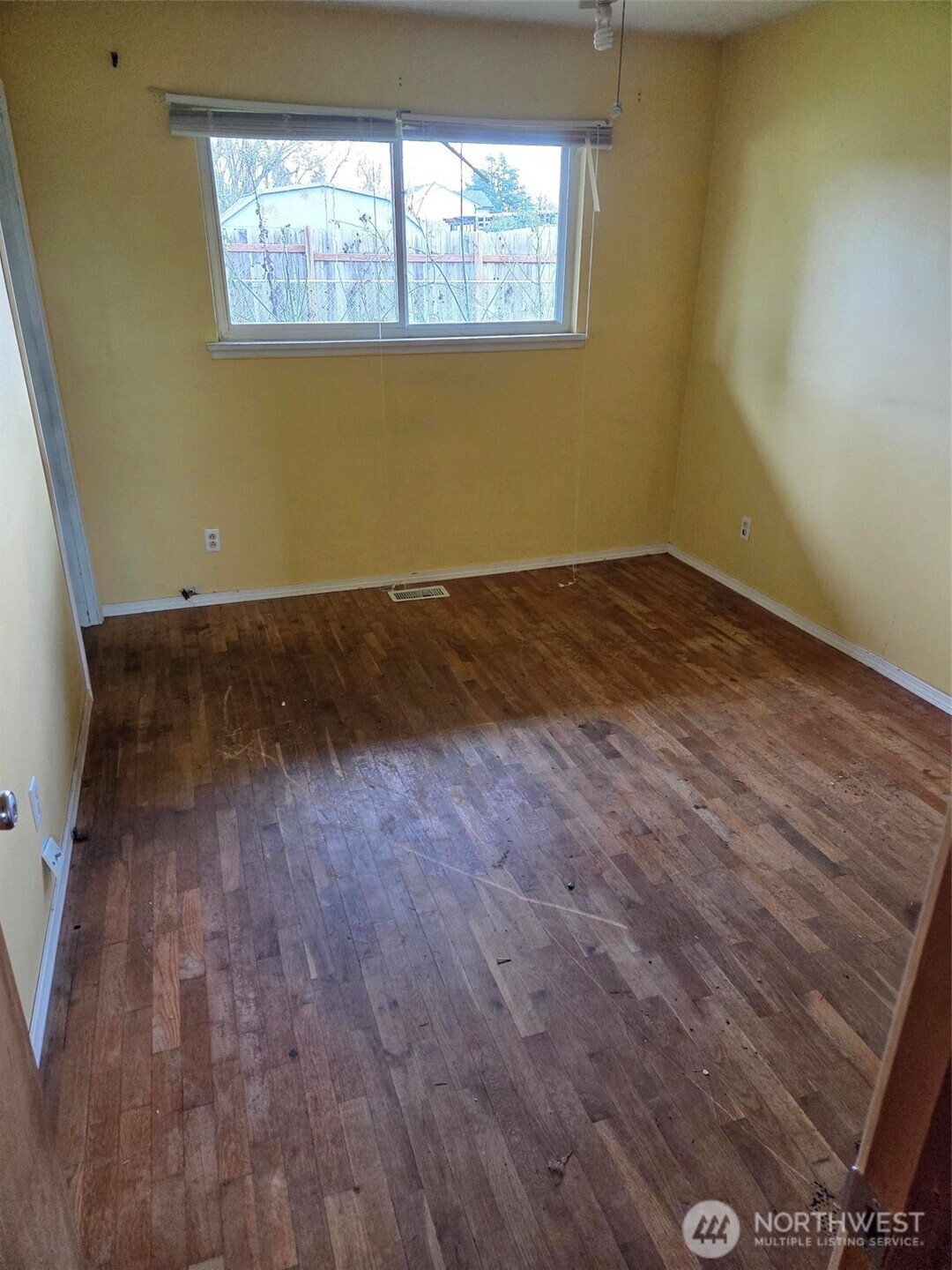 12001 Spanaway Loop Road South Tacoma, WA 98444 - Photo 13 of 20 a view of empty room with wooden floor and fan