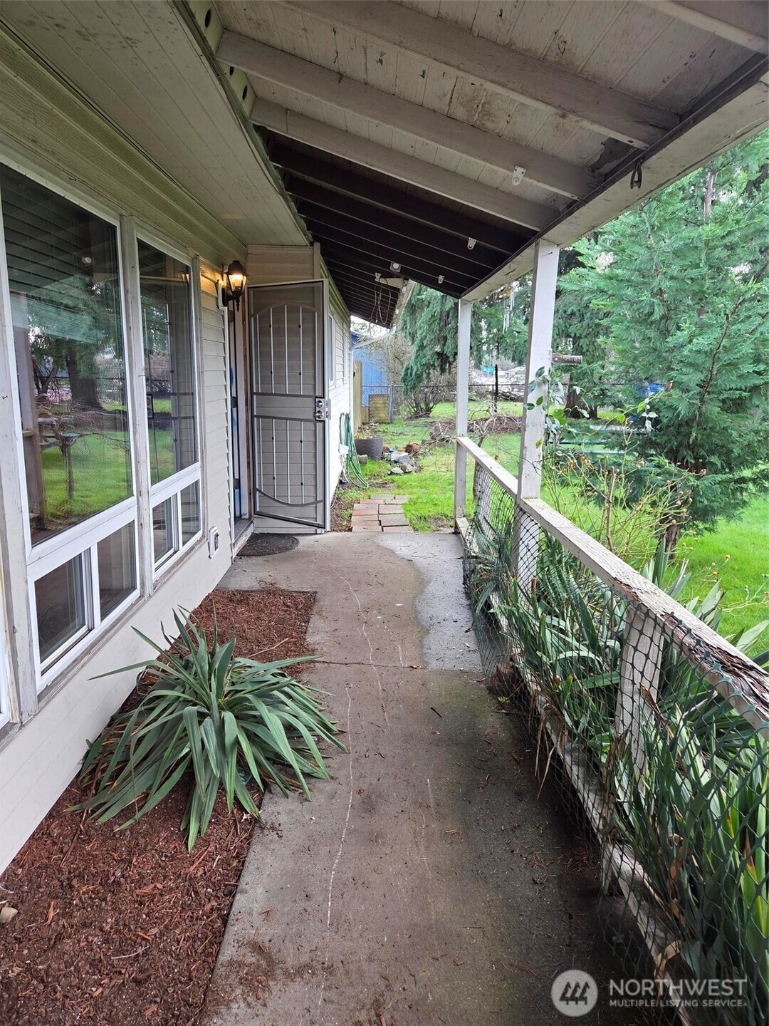 12001 Spanaway Loop Road South Tacoma, WA 98444 - Photo 2 of 20 a view of a porch with chairs and plants