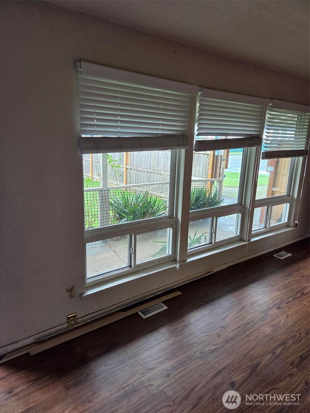 12001 Spanaway Loop Road South Tacoma, WA 98444 - Photo 3 of 20 an empty room with wooden floor and windows