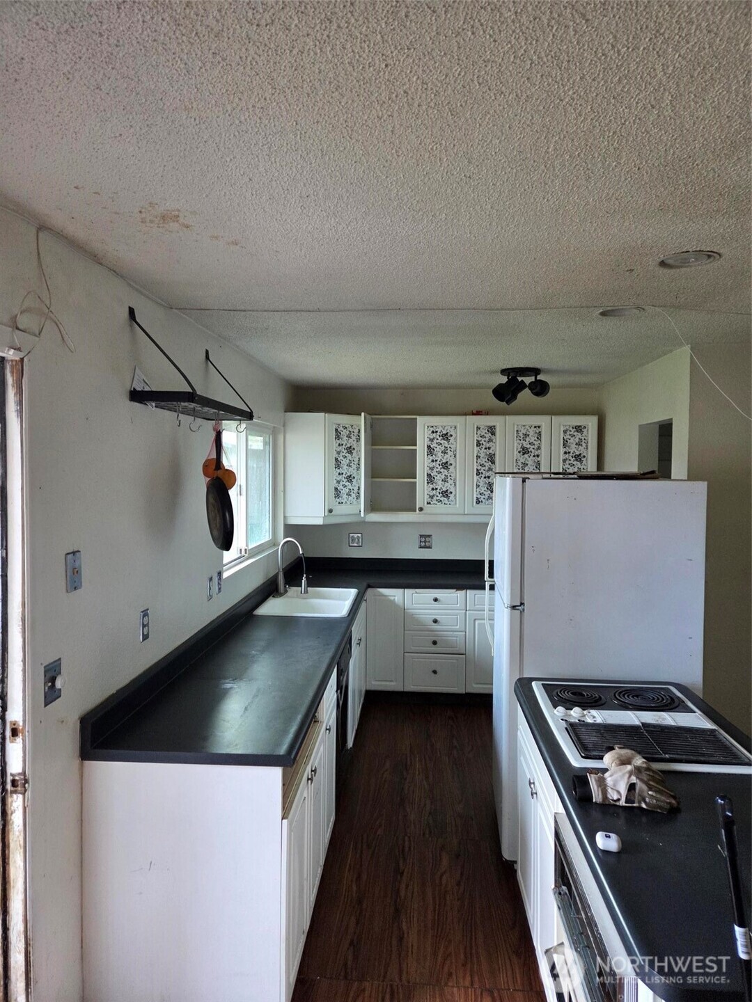 12001 Spanaway Loop Road South Tacoma, WA 98444 - Photo 8 of 20 a kitchen with a stove and a refrigerator