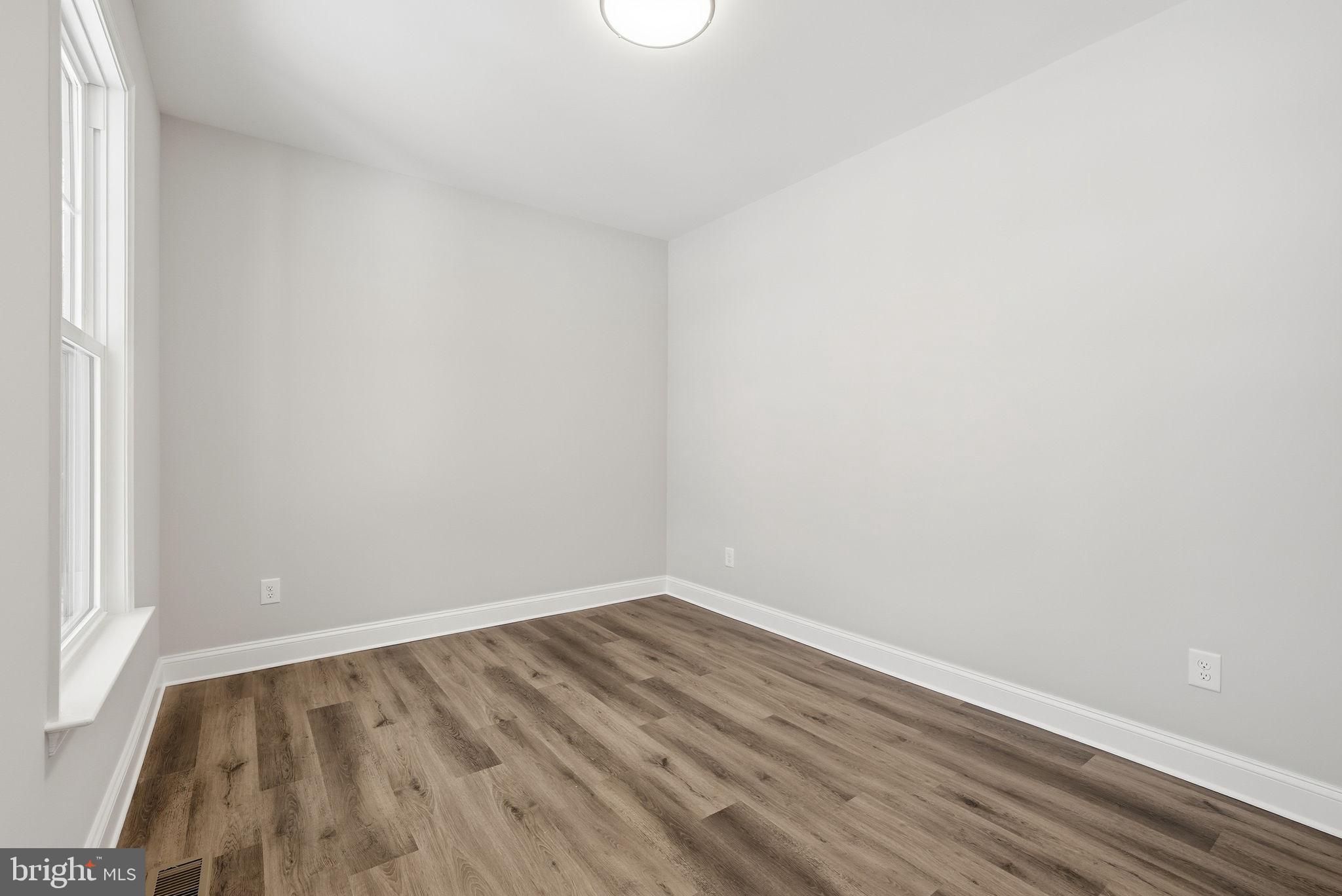 9586 South Pines Road Warrenton, VA 20186 - Photo 13 of 53 a view of an empty room with wooden floor and a window