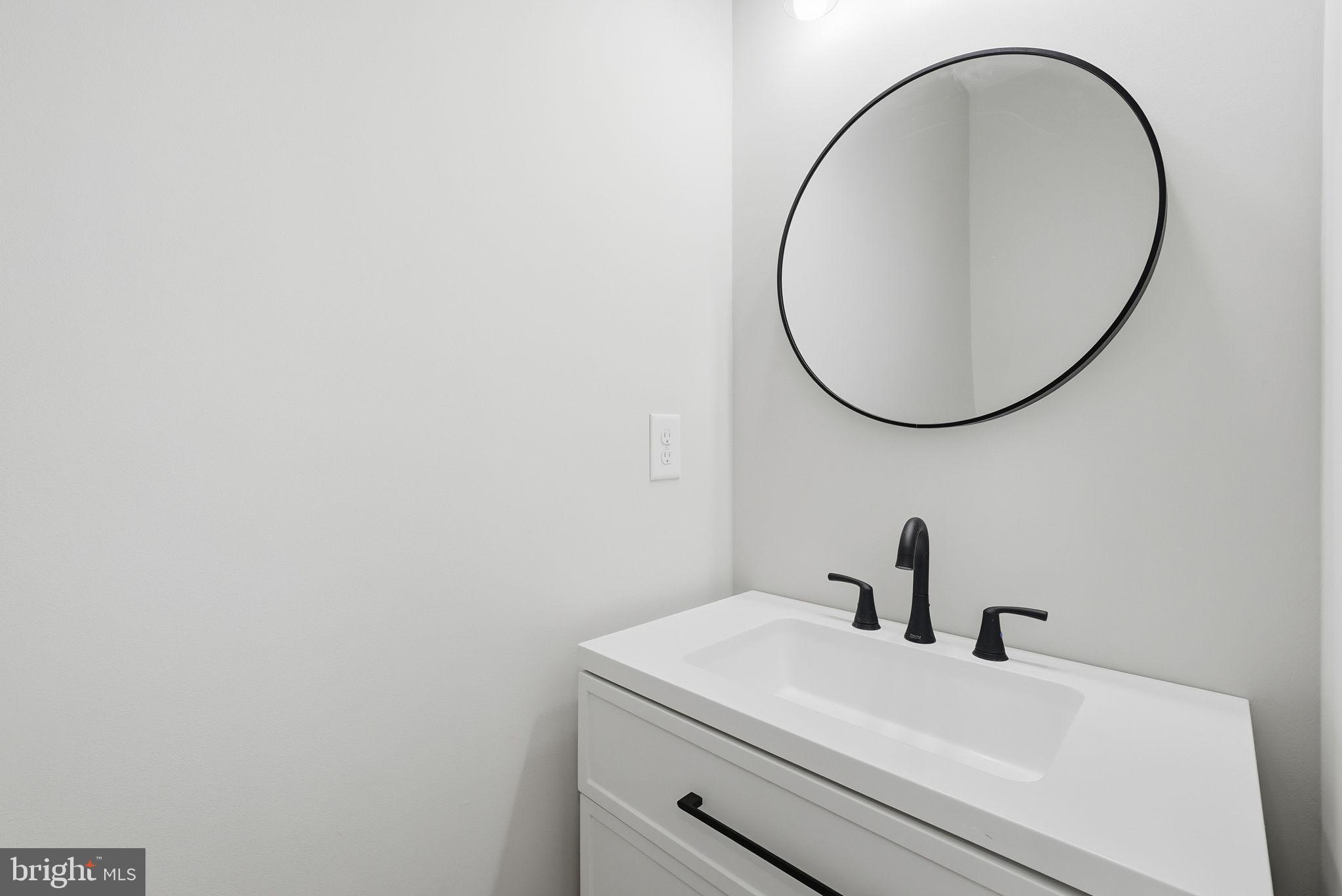 9586 South Pines Road Warrenton, VA 20186 - Photo 14 of 53 a bathroom with a sink and a mirror