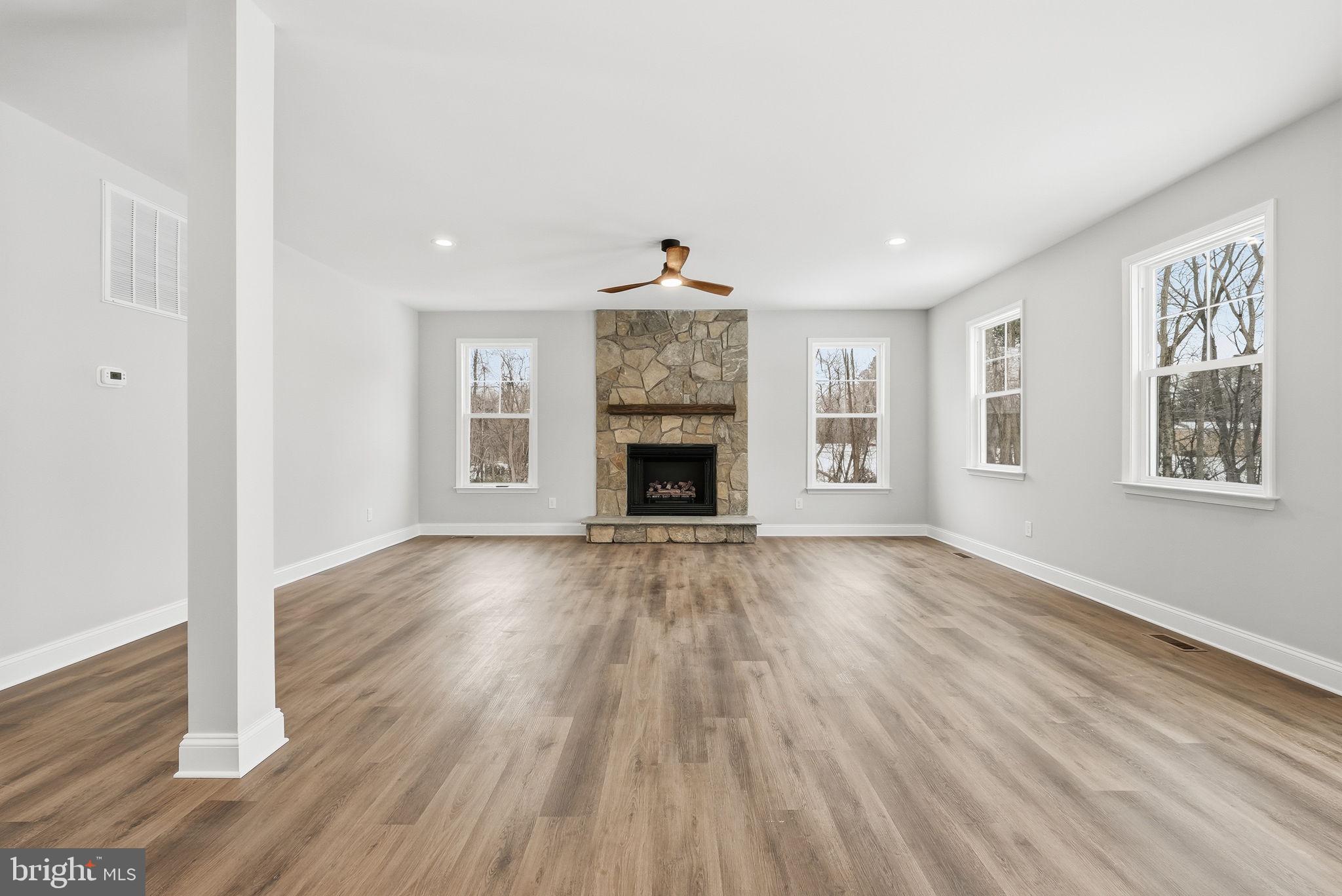 9586 South Pines Road Warrenton, VA 20186 - Photo 15 of 53 a view of an empty room with wooden floor fireplace and a window