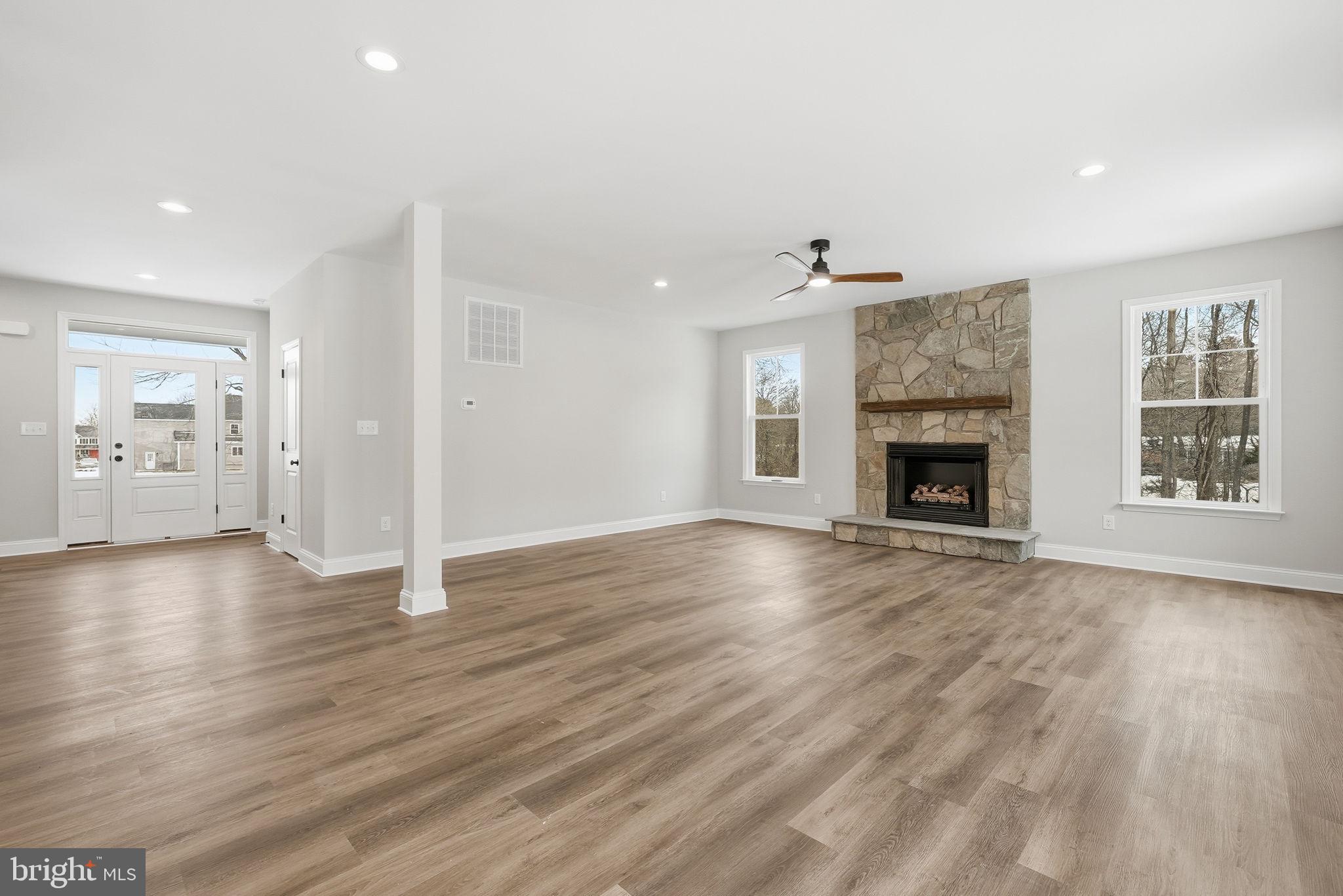 9586 South Pines Road Warrenton, VA 20186 - Photo 16 of 53 a view of an empty room with wooden floor fireplace and a window