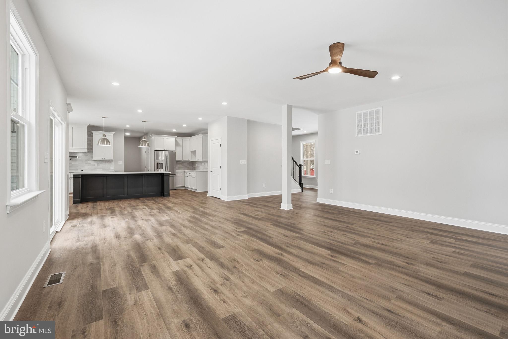 9586 South Pines Road Warrenton, VA 20186 - Photo 18 of 53 a view of kitchen and empty room with wooden floor