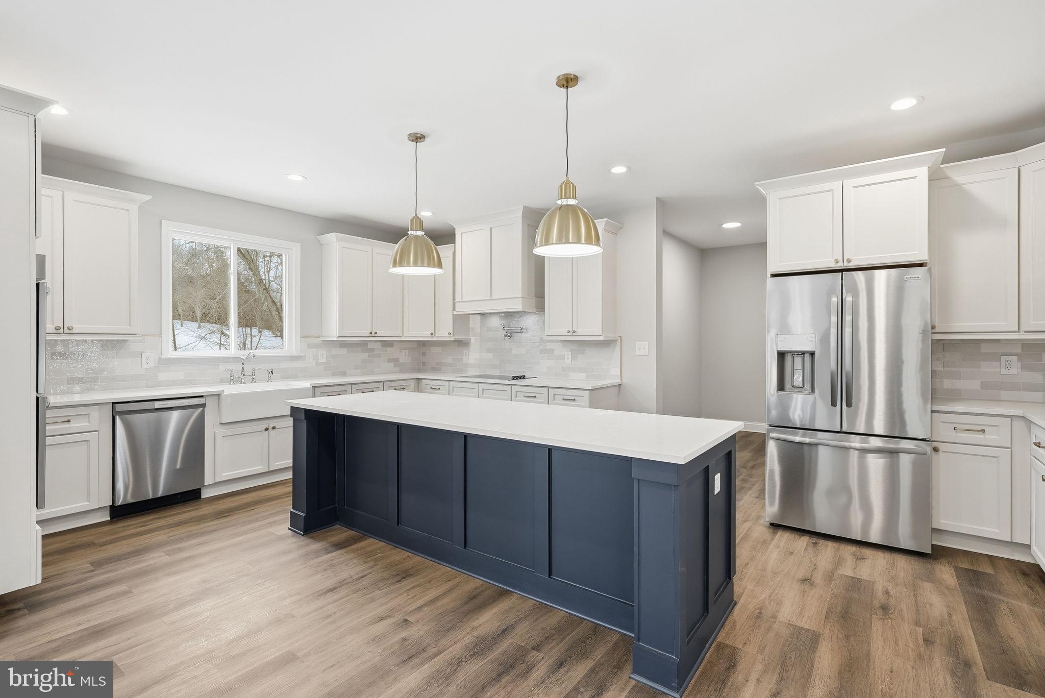 9586 South Pines Road Warrenton, VA 20186 - Photo 19 of 53 a kitchen with stainless steel appliances kitchen island granite countertop a refrigerator a sink dishwasher a stove and white cabinets with wooden floor