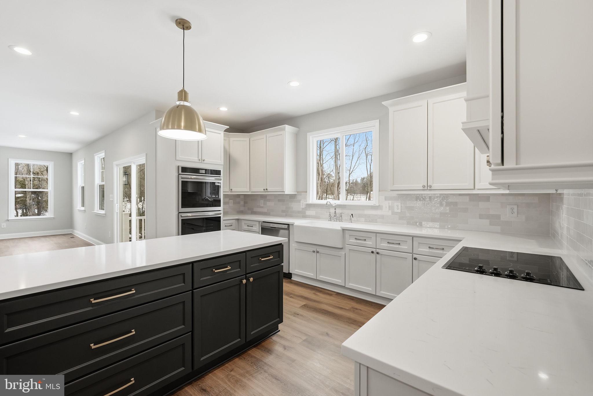 9586 South Pines Road Warrenton, VA 20186 - Photo 22 of 53 a kitchen with kitchen island granite countertop stainless steel appliances sink cabinets and window