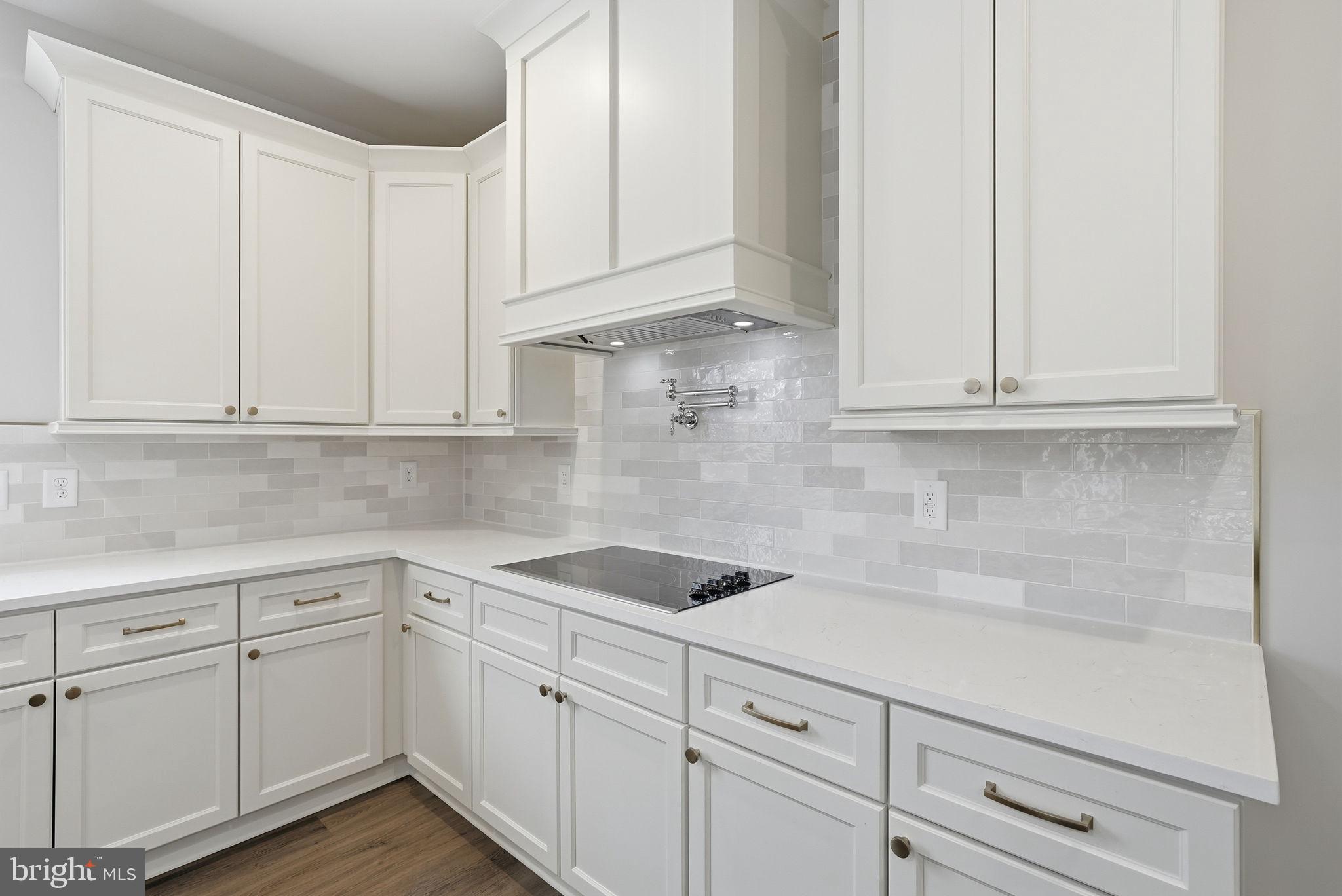 9586 South Pines Road Warrenton, VA 20186 - Photo 24 of 53 a kitchen with white cabinets and white appliances