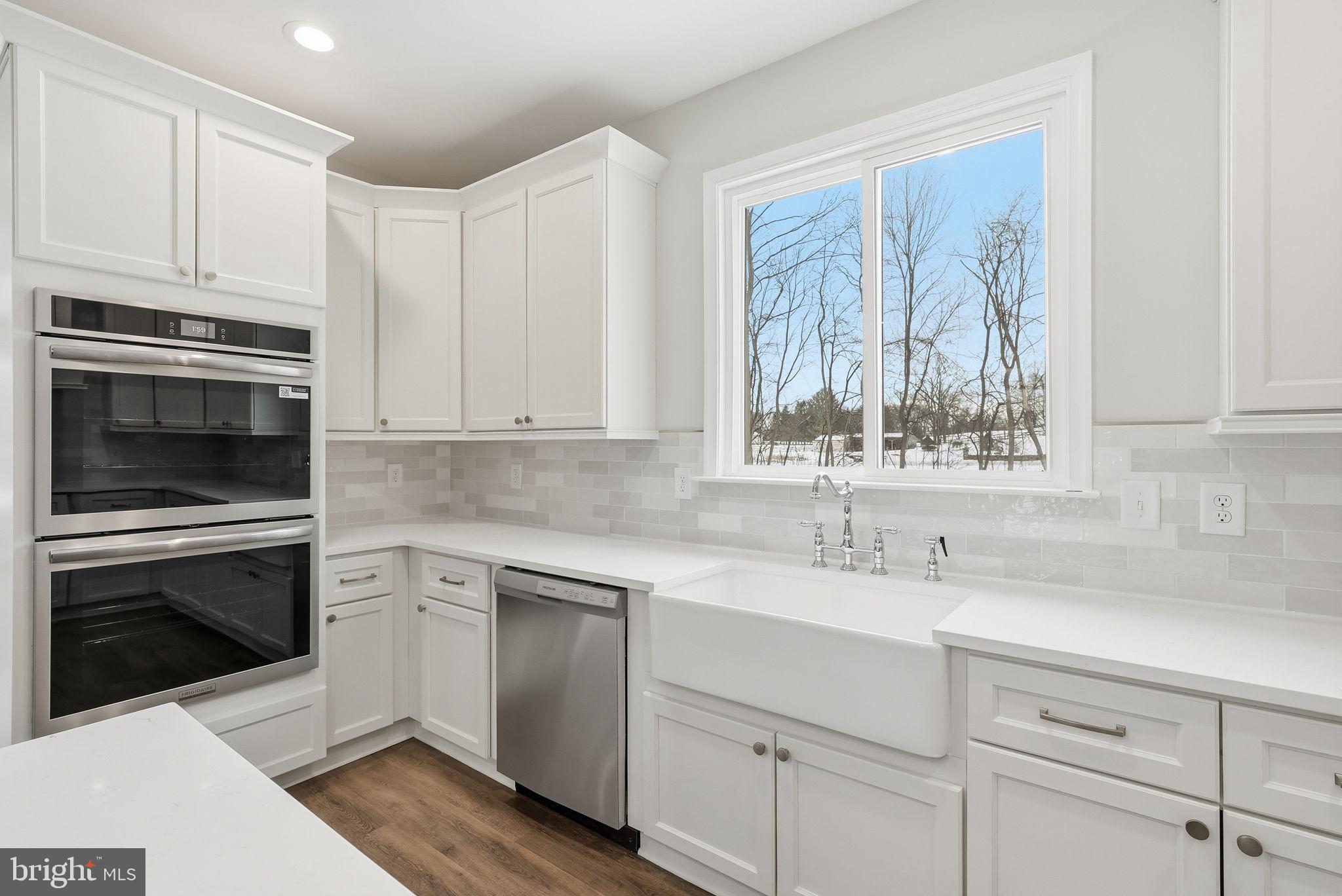 9586 South Pines Road Warrenton, VA 20186 - Photo 25 of 53 a kitchen with white cabinets stainless steel appliances and sink