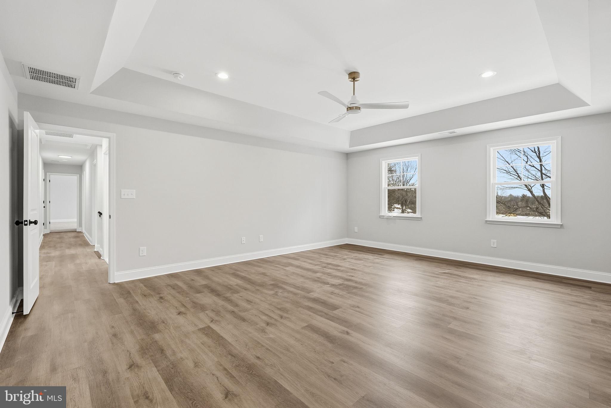 9586 South Pines Road Warrenton, VA 20186 - Photo 27 of 53 an empty room with wooden floor and windows