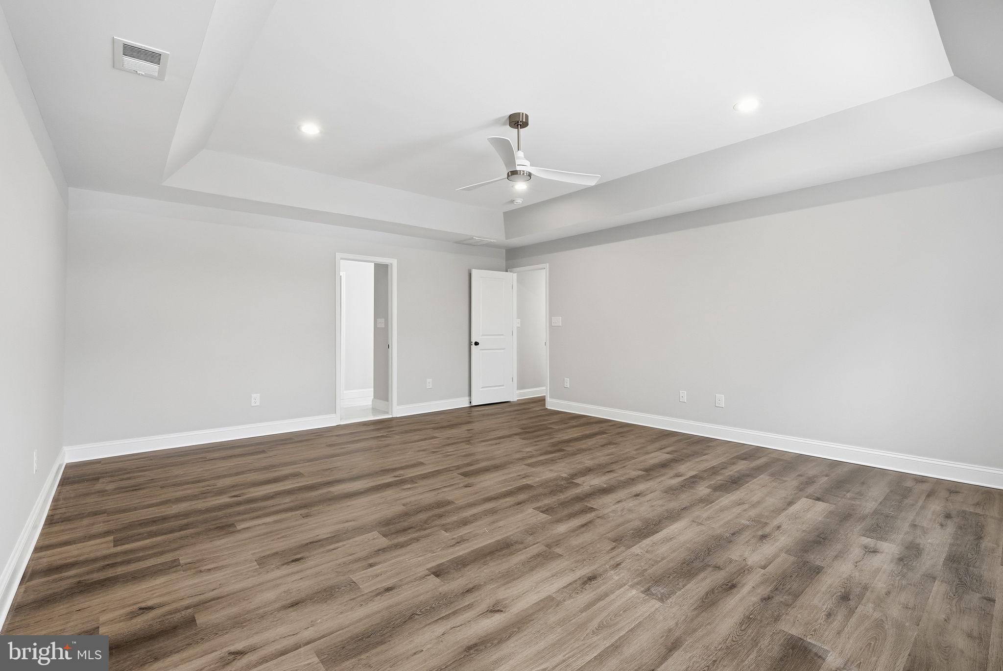 9586 South Pines Road Warrenton, VA 20186 - Photo 29 of 53 a view of an empty room with wooden floor ceiling fan