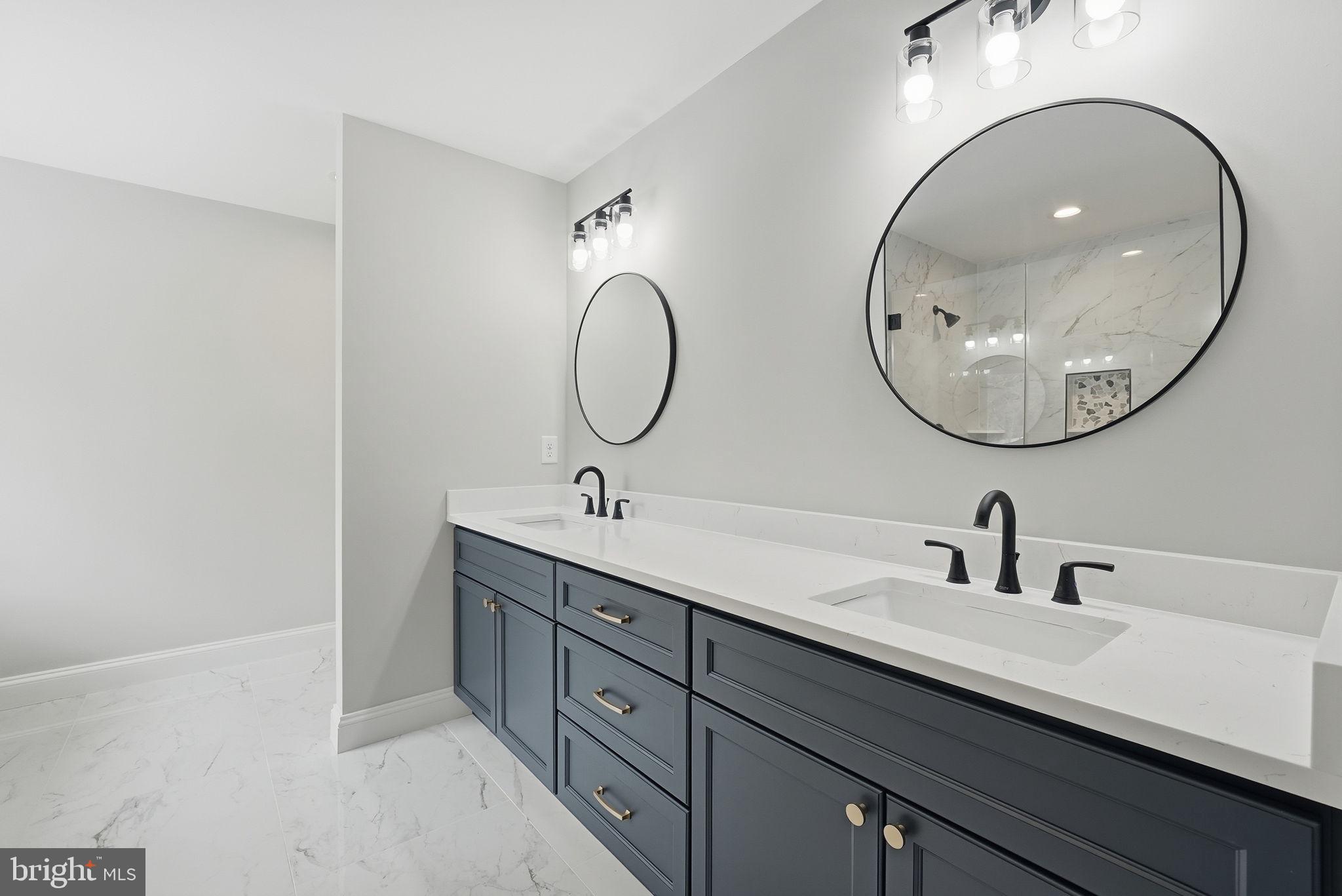 9586 South Pines Road Warrenton, VA 20186 - Photo 30 of 53 a bathroom with a double vanity sink and a mirror