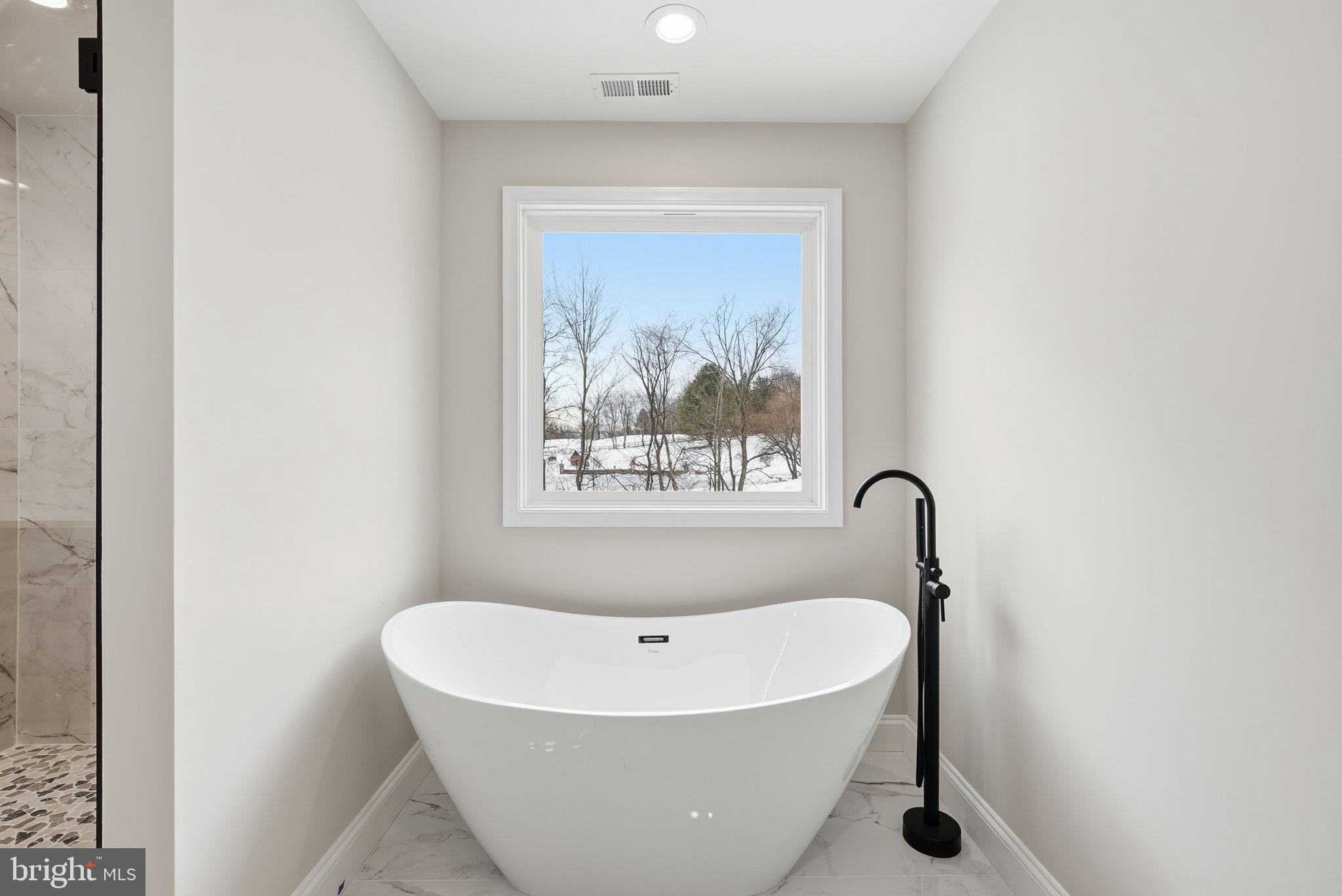 9586 South Pines Road Warrenton, VA 20186 - Photo 32 of 53 a white bath tub sitting in a bathroom
