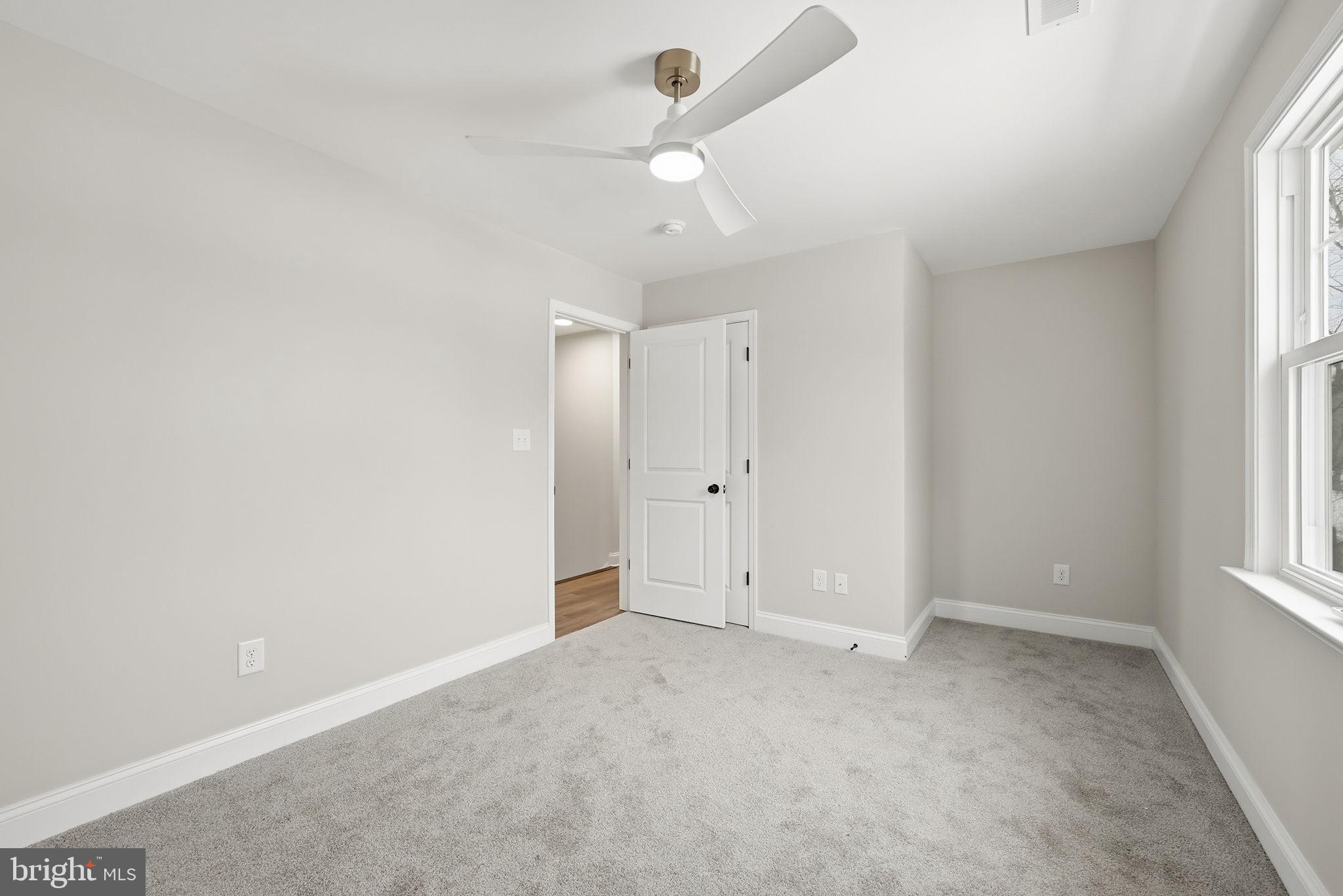 9586 South Pines Road Warrenton, VA 20186 - Photo 40 of 53 an empty room with windows and fan