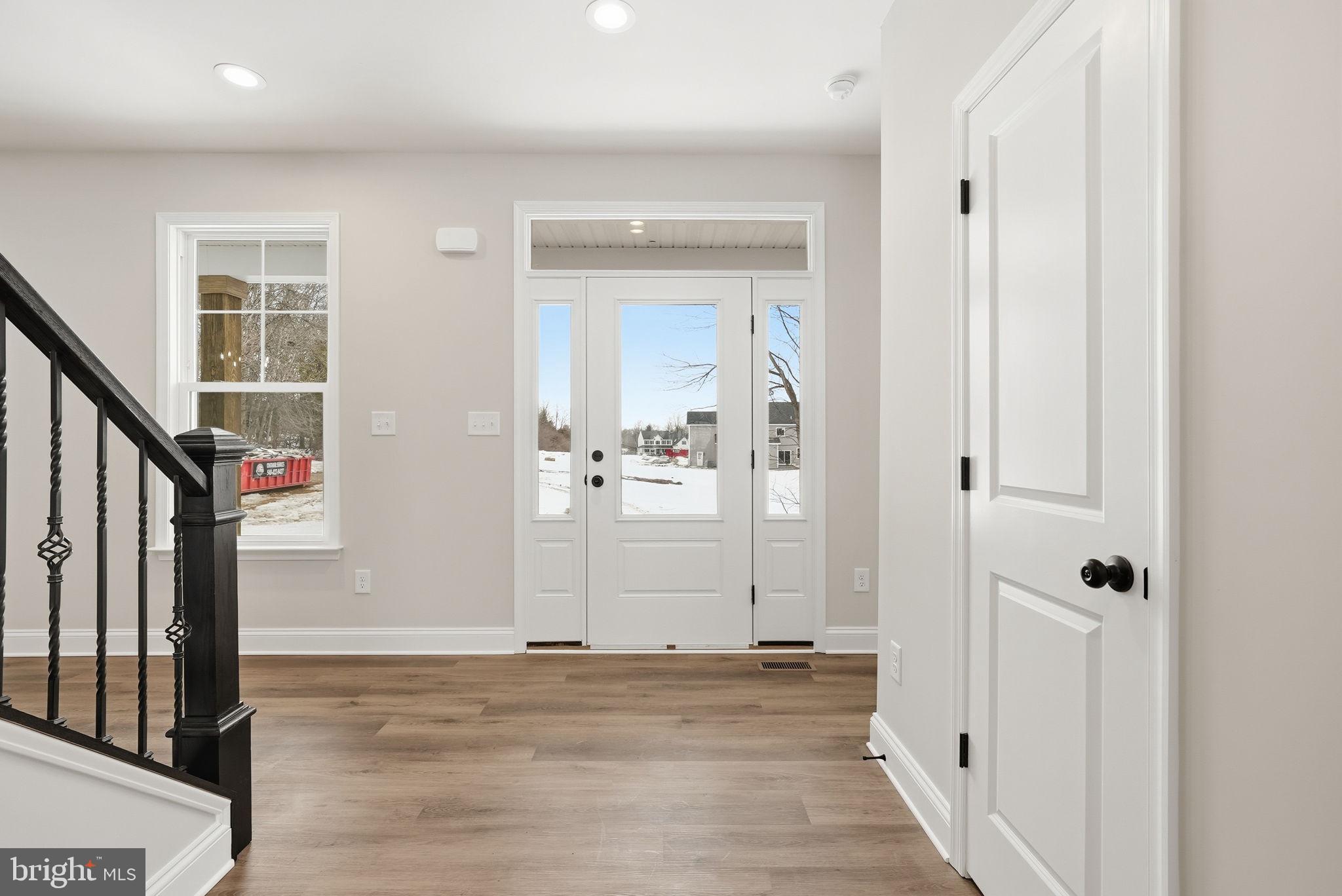 9586 South Pines Road Warrenton, VA 20186 - Photo 5 of 53 an empty room with wooden floor and windows