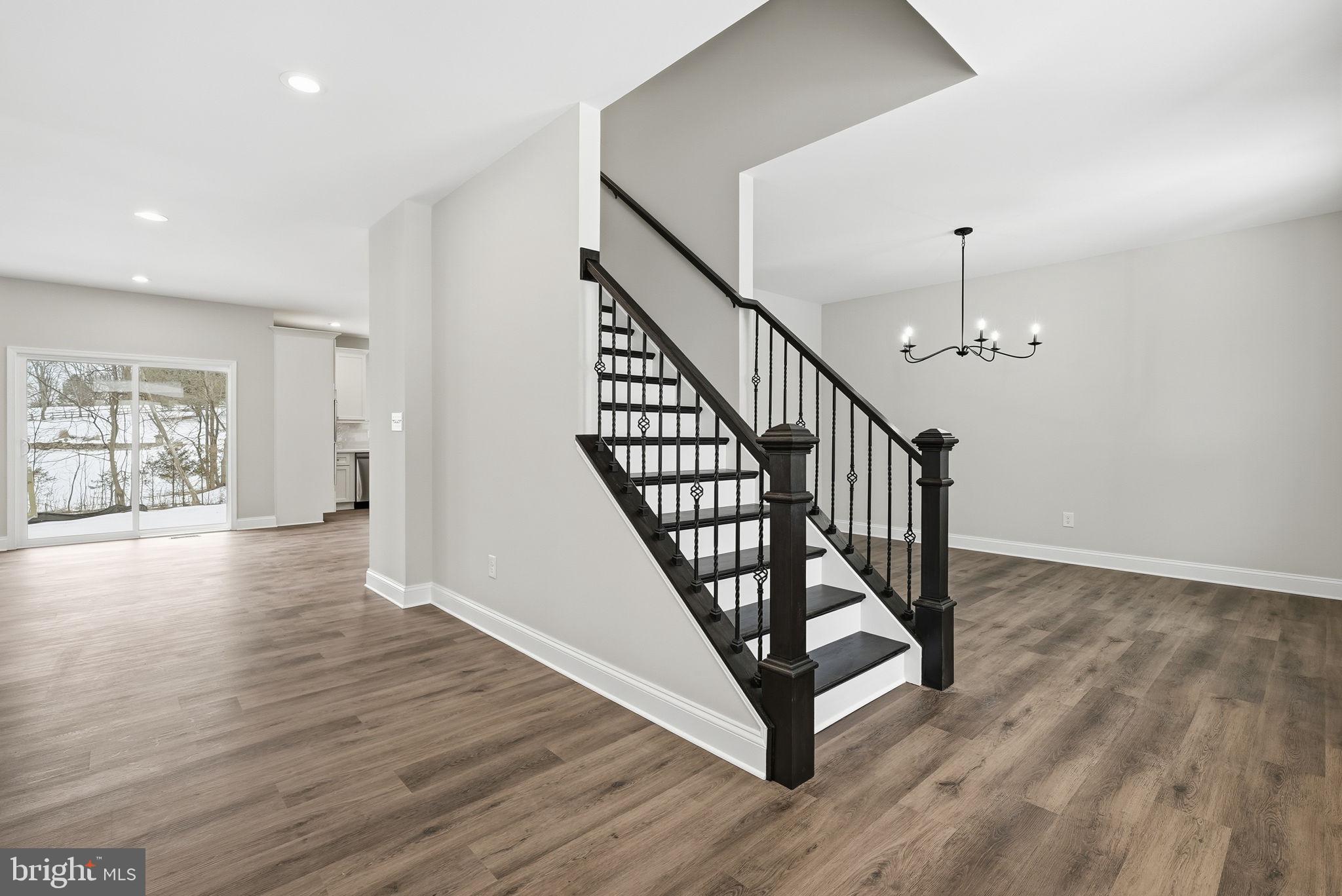 9586 South Pines Road Warrenton, VA 20186 - Photo 6 of 53 a view of a hallway with wooden floor and staircase