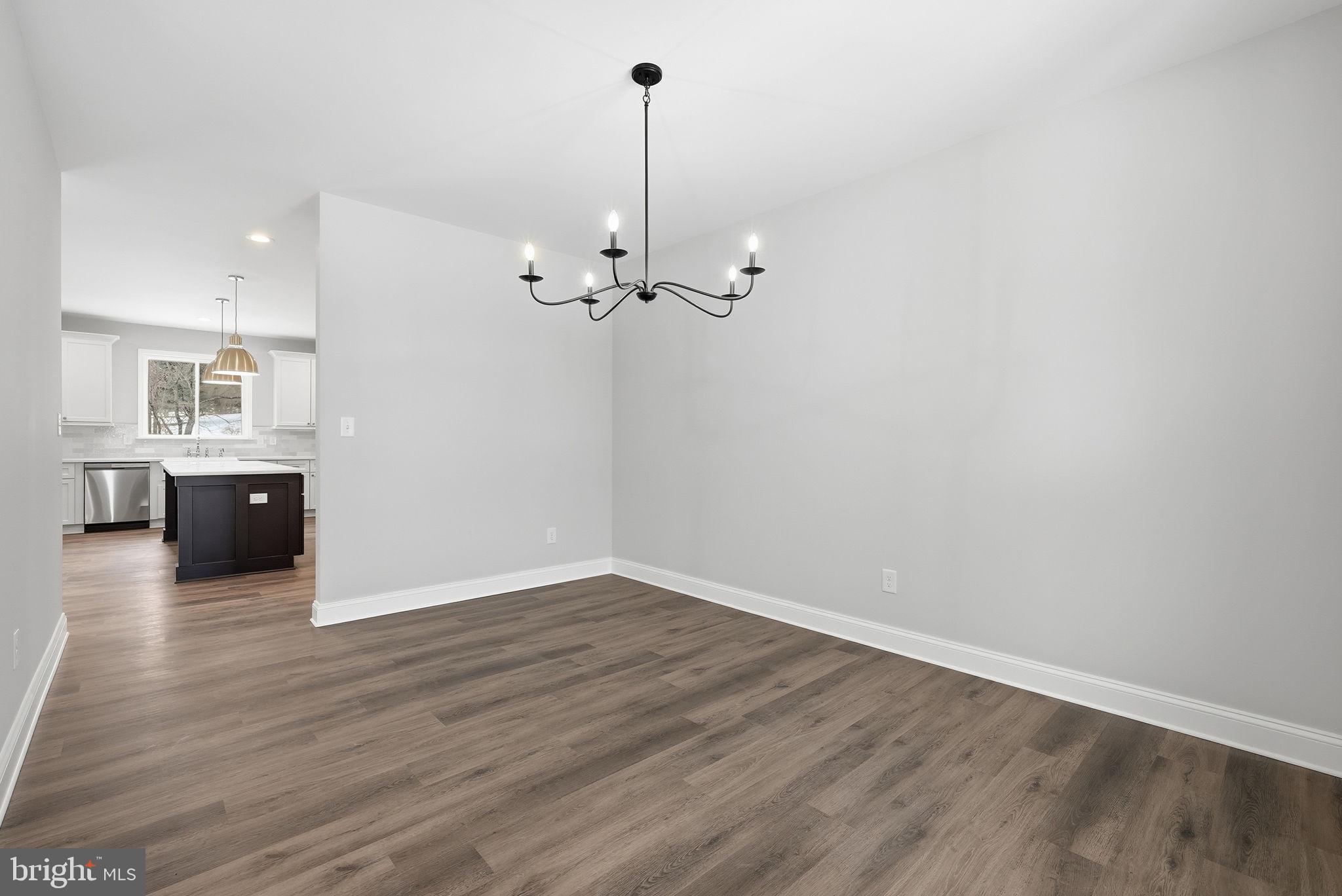 9586 South Pines Road Warrenton, VA 20186 - Photo 9 of 53 a view of an empty room with wooden floor and a cabinet