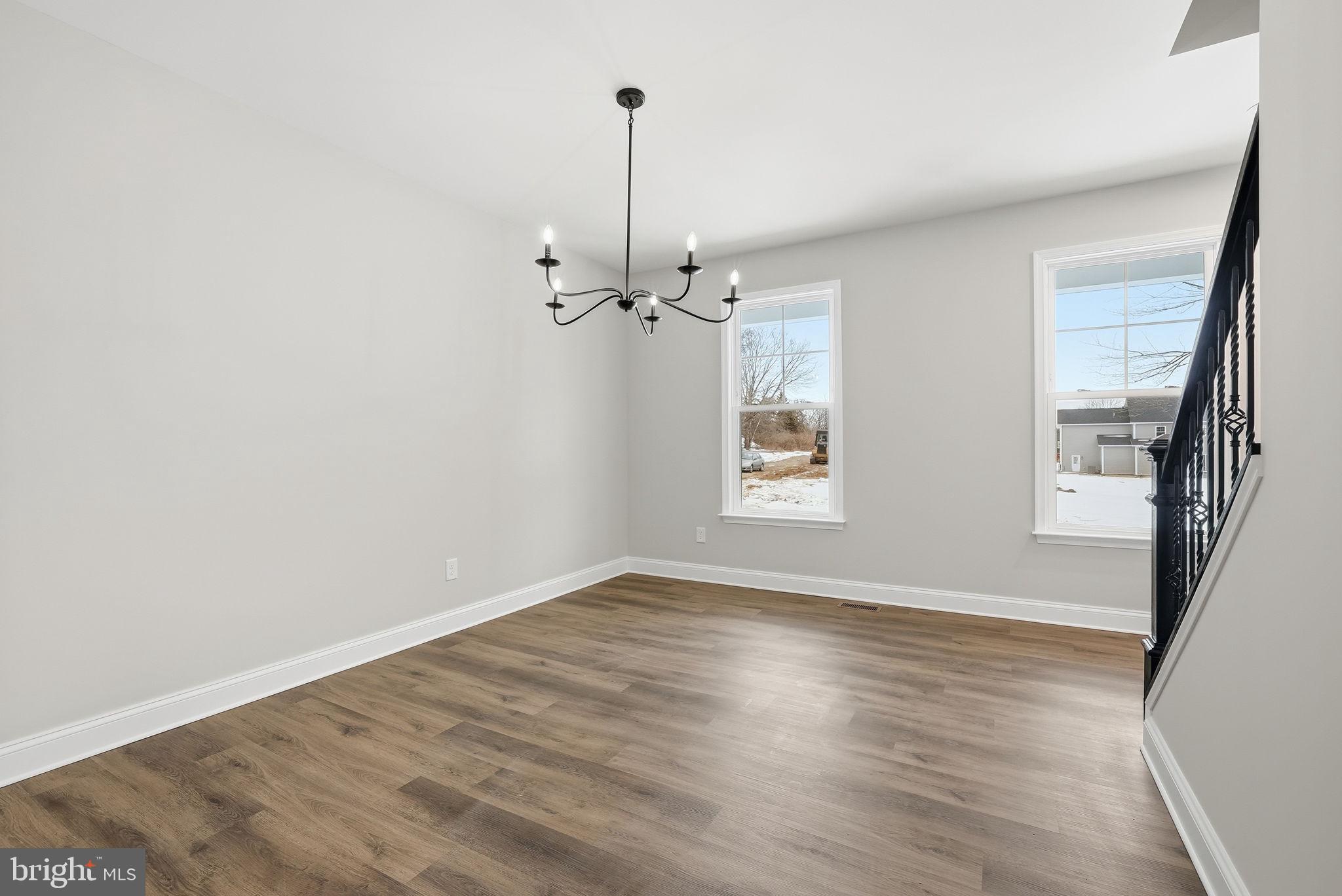 9586 South Pines Road Warrenton, VA 20186 - Photo 10 of 53 a view of a room with wooden floor staircase and a kitchen