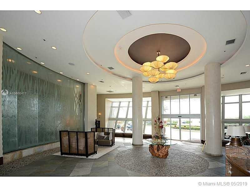 2641 North Flamingo Road, Unit 2103N Sunrise, FL 33323 - Photo 2 of 5 a living room with furniture and a large window
