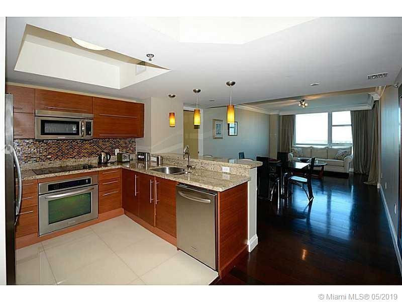 2641 North Flamingo Road, Unit 2103N Sunrise, FL 33323 - Photo 4 of 5 a kitchen with stainless steel appliances granite countertop a stove and cabinets