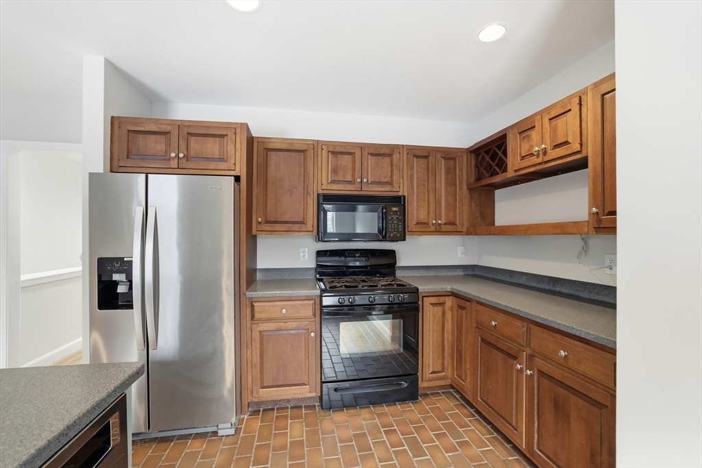 74 Branch Street, Unit 15 Scituate, MA 02066 - Photo 10 of 26 a kitchen with stainless steel appliances granite countertop a sink stove and refrigerator