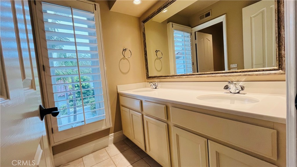 19 Terraza Del Mar Dana Point, CA 92629 - Photo 18 of 25 a bathroom with a double vanity sink and a mirror