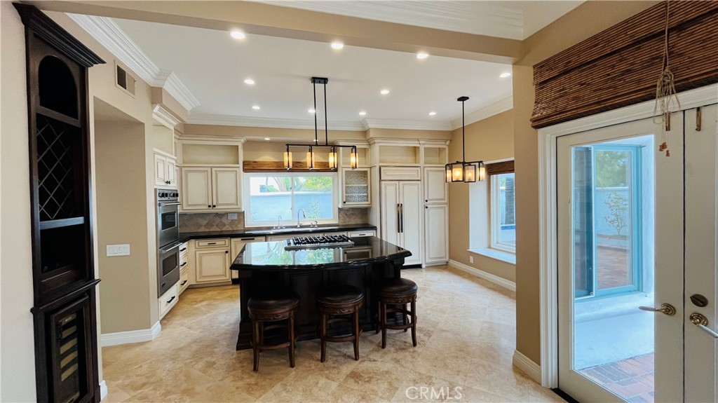 19 Terraza Del Mar Dana Point, CA 92629 - Photo 4 of 25 a kitchen with stainless steel appliances kitchen island granite countertop a refrigerator and a stove top oven
