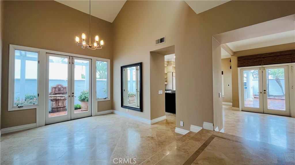 19 Terraza Del Mar Dana Point, CA 92629 - Photo 5 of 25 a view of a hallway with wooden floor and a livingroom