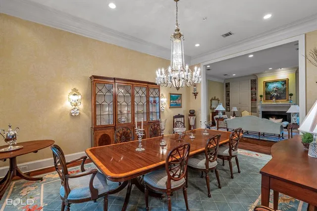 a view of a dining room with furniture a chandelier and wooden floor