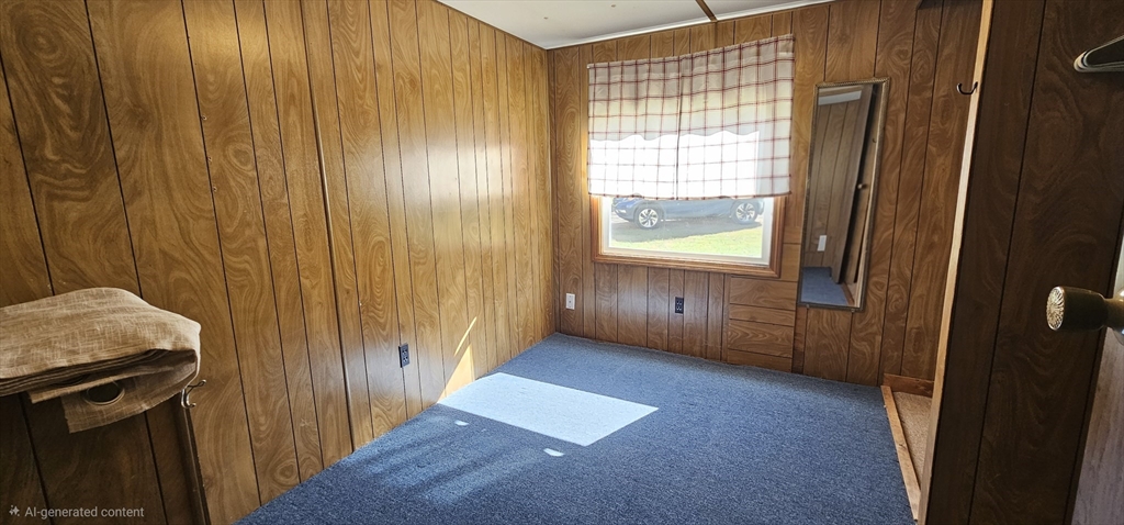 46 Madden Road, Unit 39 West Brookfield, MA 01585 - Photo 11 of 15 a view of an empty room with wooden floor and a window