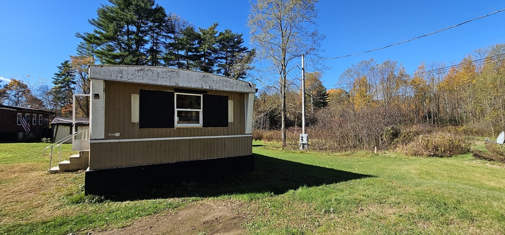 46 Madden Road, Unit 39 West Brookfield, MA 01585 - Photo 2 of 15 a front view of a house with a yard