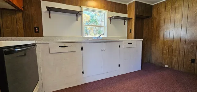 a kitchen with a sink and a mirror