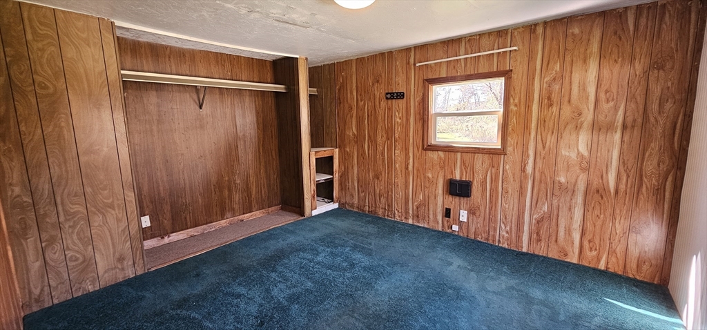 46 Madden Road, Unit 39 West Brookfield, MA 01585 - Photo 10 of 15 a view of an empty room with wooden walls