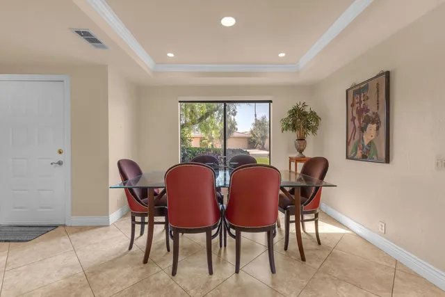 a view of a dining room with furniture a couch and wooden floor