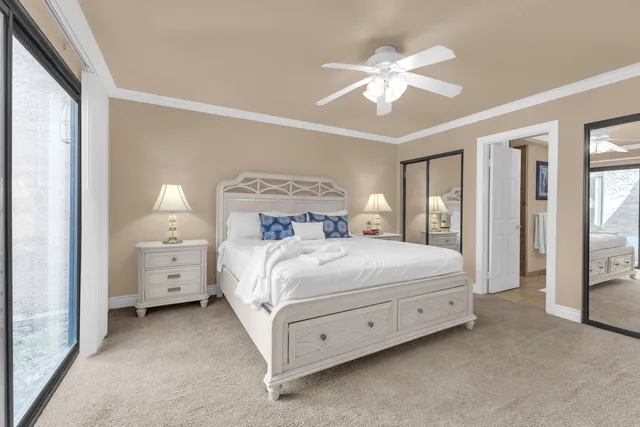 a spacious bedroom with a bed and a chandelier