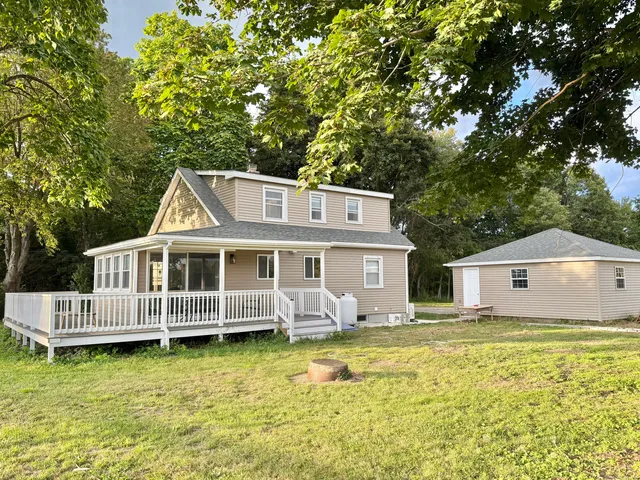 a view of a house with a backyard