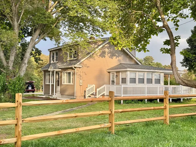 a front view of a house with a yard table and chairs