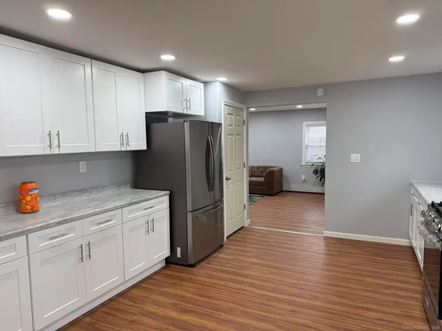a kitchen with stainless steel appliances a refrigerator and wooden cabinets