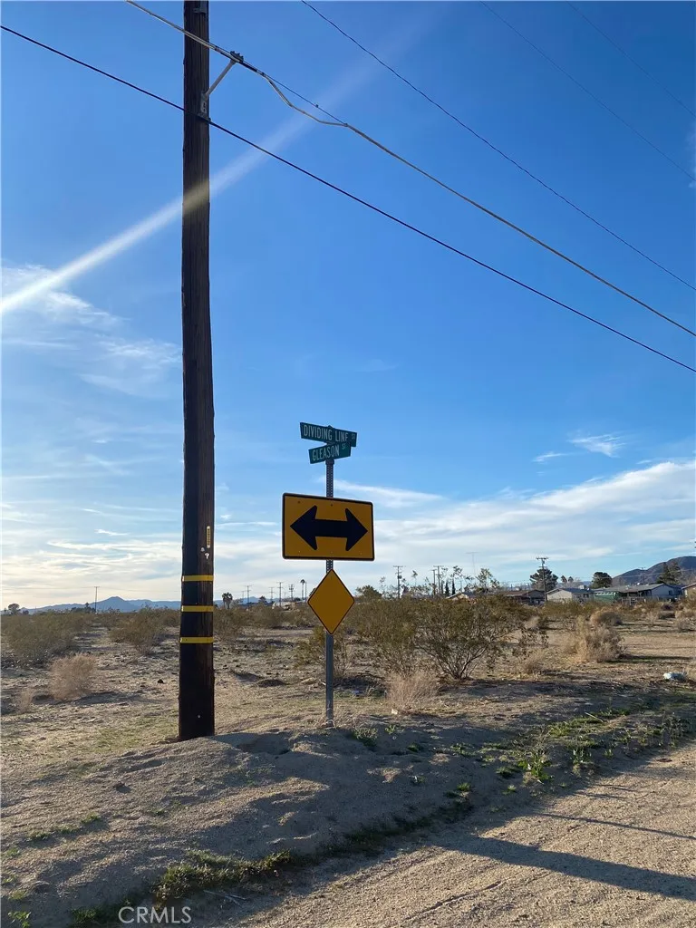 a street sign on a sidewalk next to a road