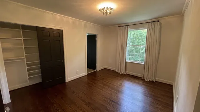 a view of a livingroom with furniture wooden floor and window