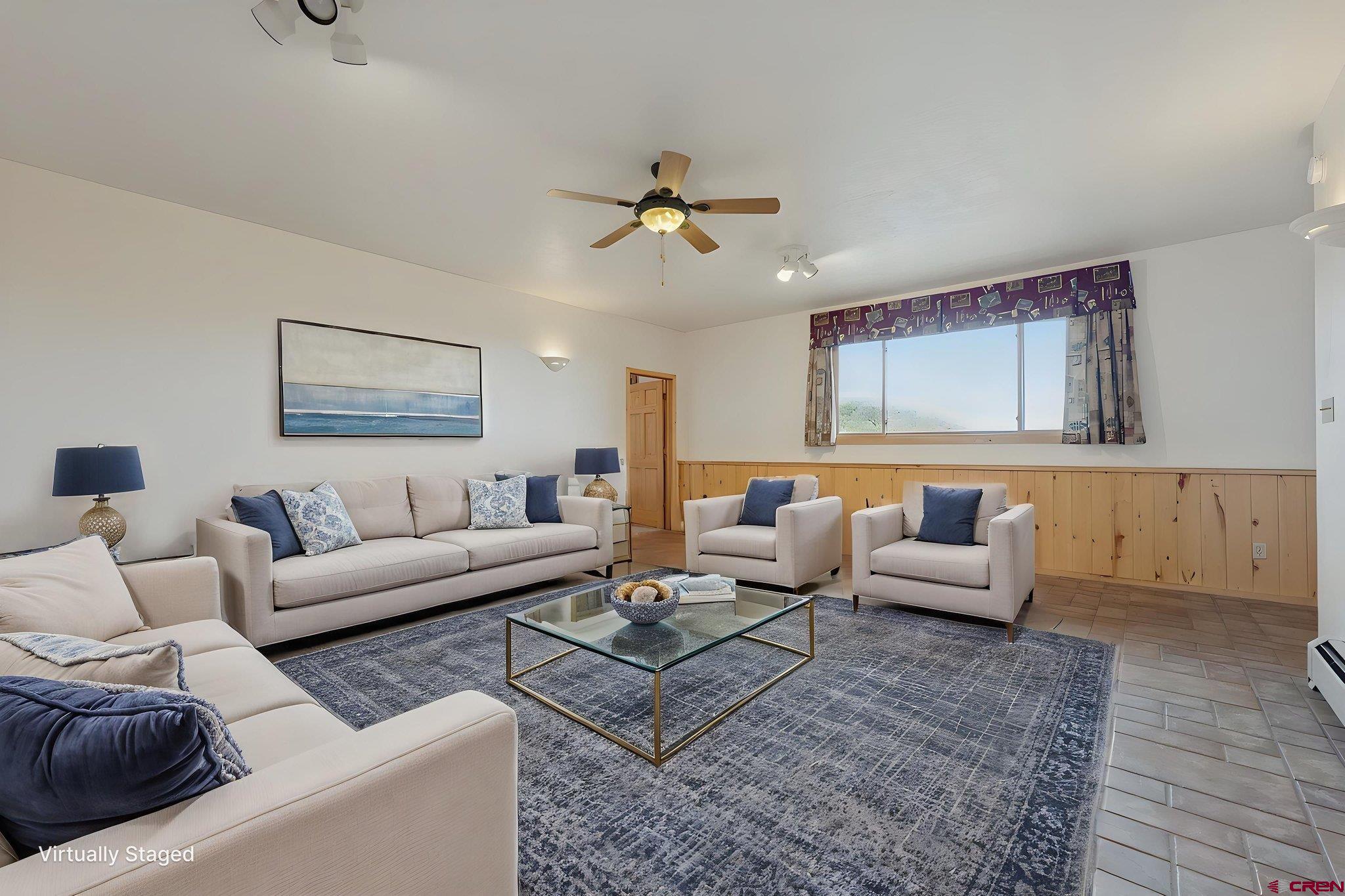 481 Far View Road Durango, CO 81303 - Photo 24 of 45 a living room with furniture ceiling fan and a rug