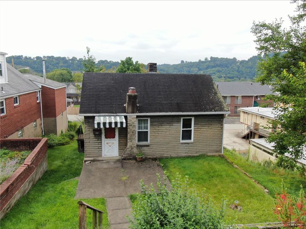 aerial view of a house with a yard